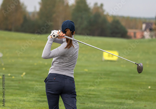 Girl practicing playing golf on the golf course