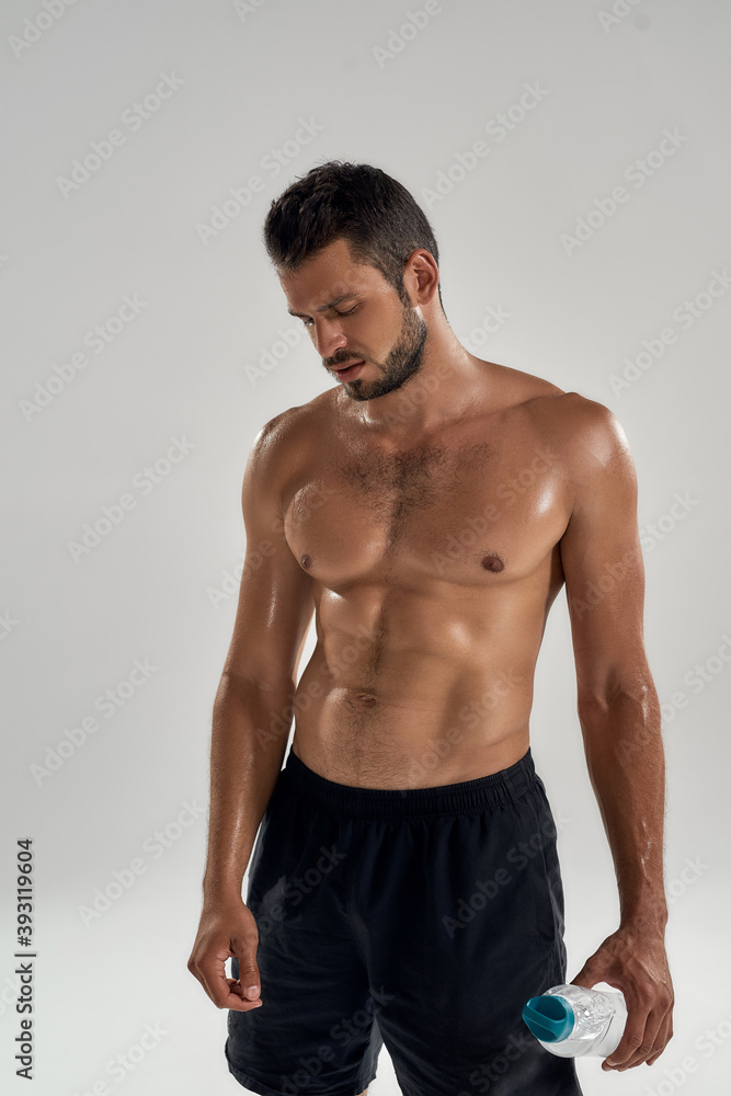 Young handsome muscular caucasian man with lowered head Young handsome muscular caucasian man with lowered head