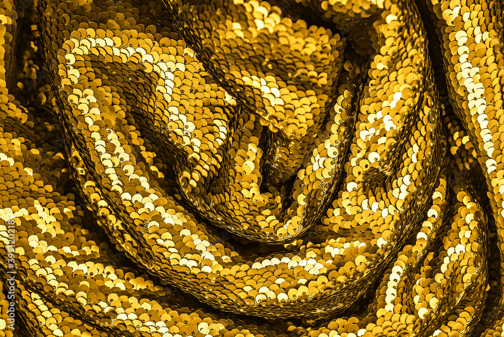 Golden shiny fabric with sequins, abstract background. Golden shiny fabric with sequins, abstract background.
