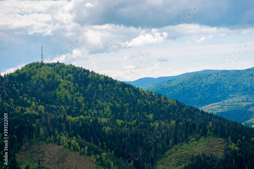 rolling hills of mountain landscape. cloudy day in carpathian mountains. ridge in the distance. beautiful nature background in springtime