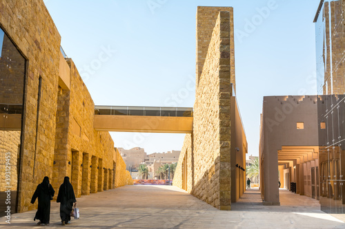 Arabic women walking in the Diraiyah, also as Dereyeh and Dariyya, a town in Riyadh, Saudi Arabia, was the original home of the Saudi royal family, and served as the capital of Emirate of Diriyah. photo