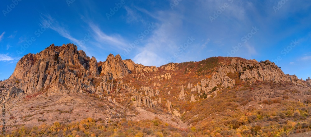 View of the Valley of Ghosts in Demerdzhi in the Crimean Mountains. Column pillars rise into the blue sky  (Panorama)