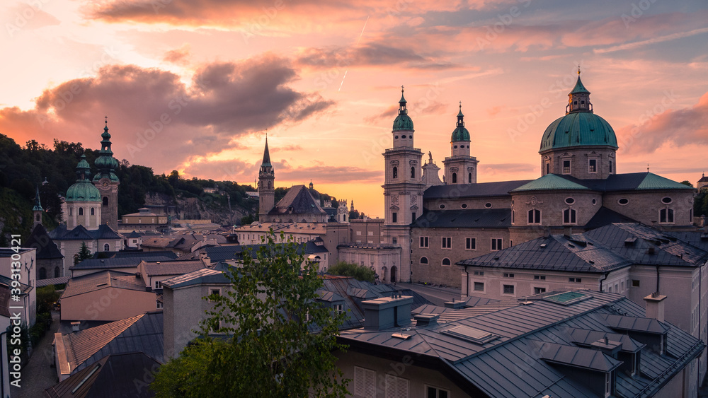 The skyline of Salzburg in Austria seen from the famous fortress Hohensalzburg with the cathedral during sunset