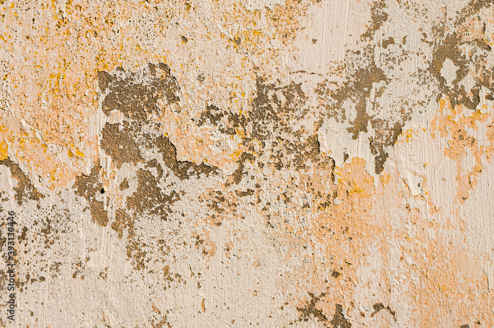 Grunge background of cracked cloud peeled putty wall in beige tones