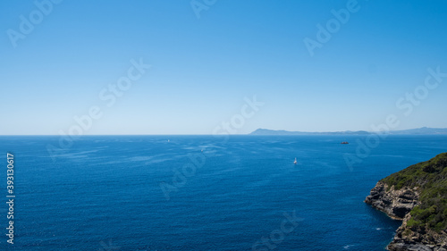 Boat sailing on the blue sea and infinite horizon, 