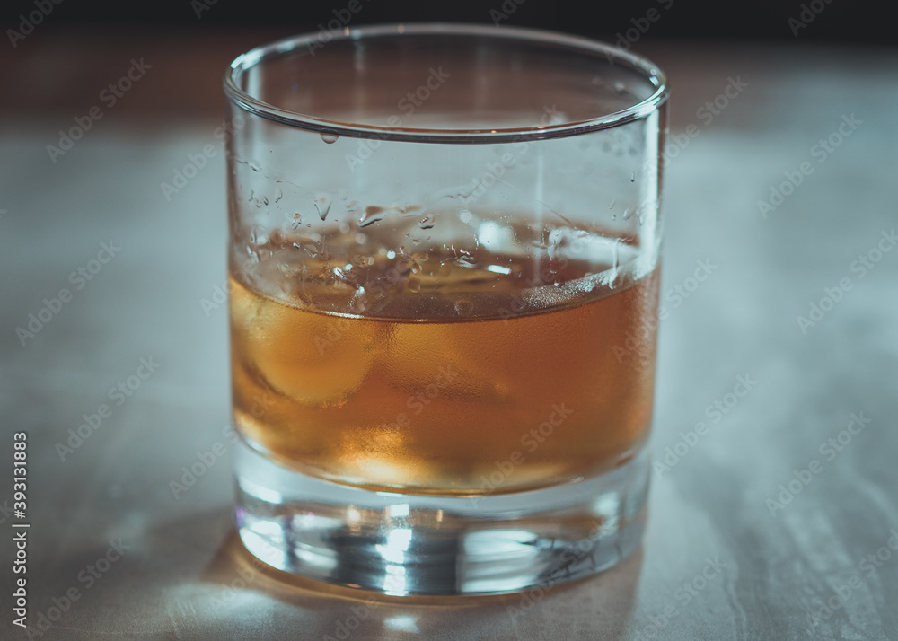 A glass of rum on the rocks. A glass of rum on the rocks.