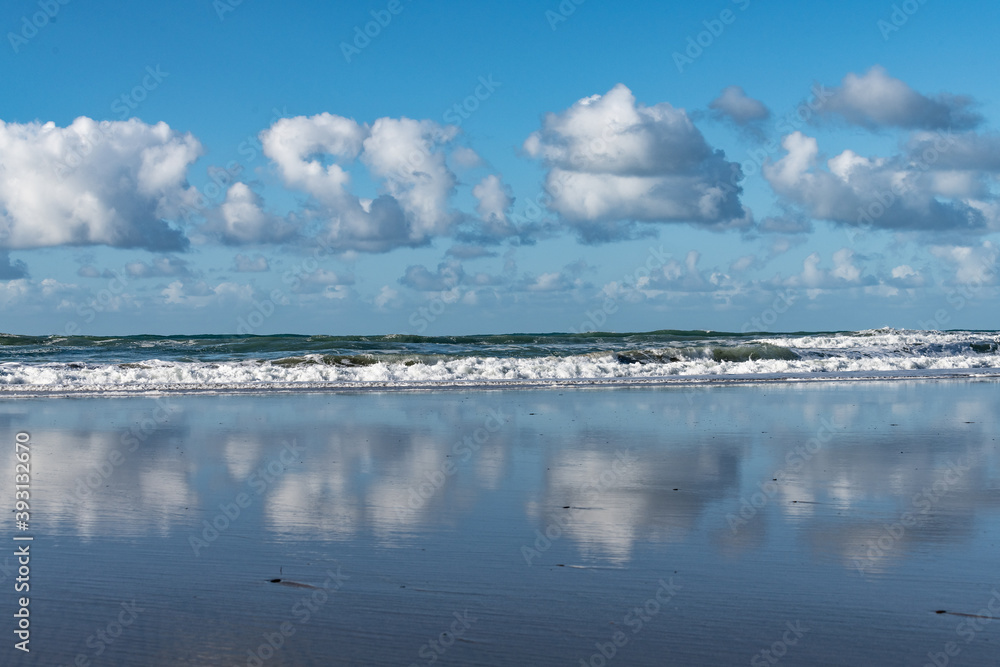 sky, clouds and wet sand at the coast