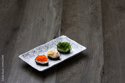 Sushi Set sashimi and sushi rolls served on wood background