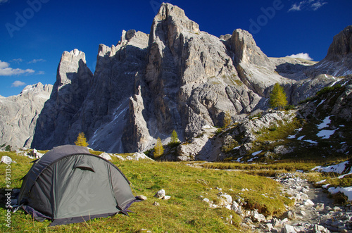Tourist green tent overlooking the beautiful Dolomites in sunny weather