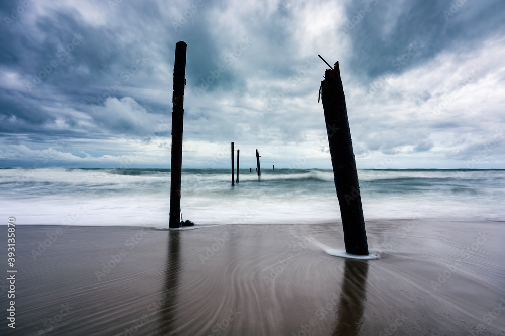 Big wave hitting a decay wooden bridge on the beach in stormy weather at Pilai beach, Phang nga Big wave hitting a decay wooden bridge on the beach in stormy weather at Pilai beach, Phang nga