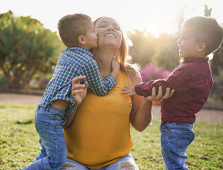Happy single mother with twin sons in nature park - Family day - Mother and children love