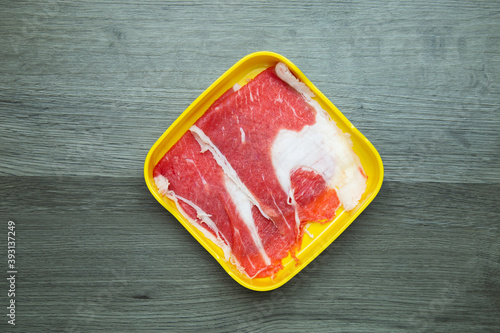 fresh raw pork, meat ,beef, belly, sliced on square plate  on wood, wooden background,set shabu, hot pot ingredients.