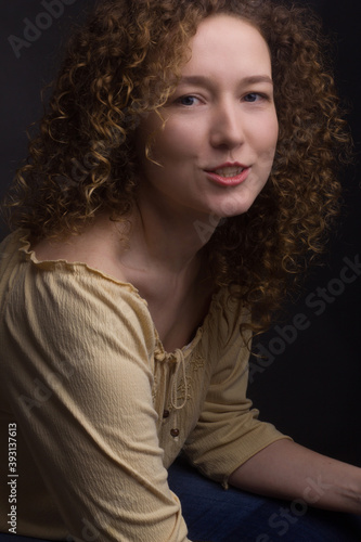 Studio portrait of young woman with curly hair