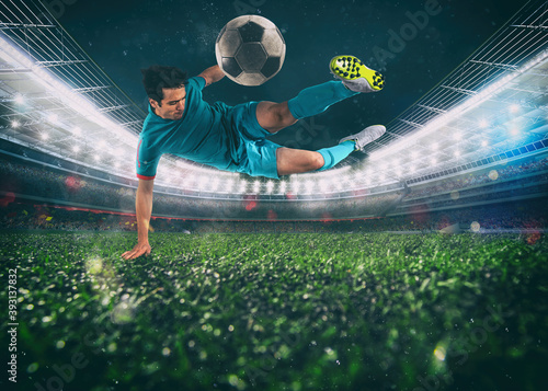 Soccer striker hits the ball with an acrobatic kick in the air at the stadium © alphaspirit