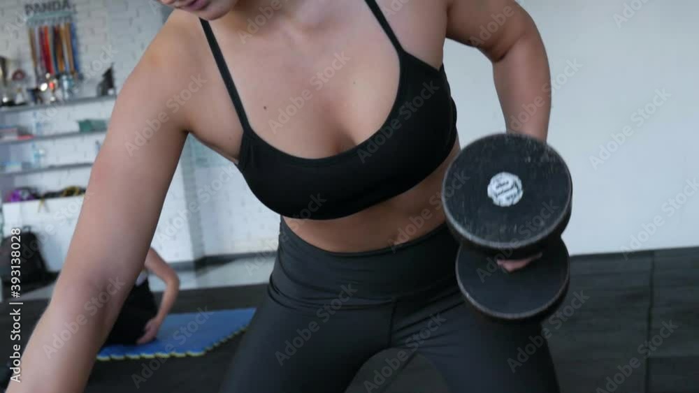 Young girl trains in the gym. Sexy female model is engaged in fitness. Young girl trains in the gym. Sexy female model is engaged in fitness.
