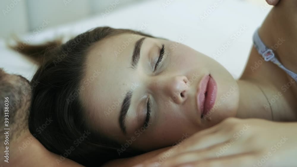 Beautiful young girl sleeping on man's chest. Close-up shot of beautiful sleeping girl's face. 4K Beautiful young girl sleeping on man's chest. Close-up shot of beautiful sleeping girl's face. 4K