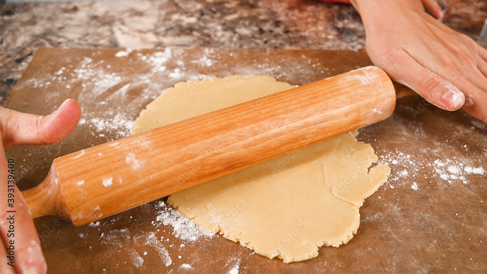 rolling pin rolls dough close up rolling pin rolls dough close up