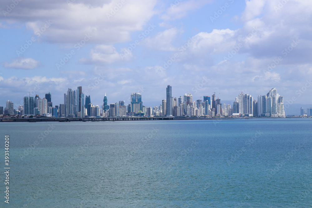 Skyline in distance with gulf front on cloudy day; cityscape background with copy space