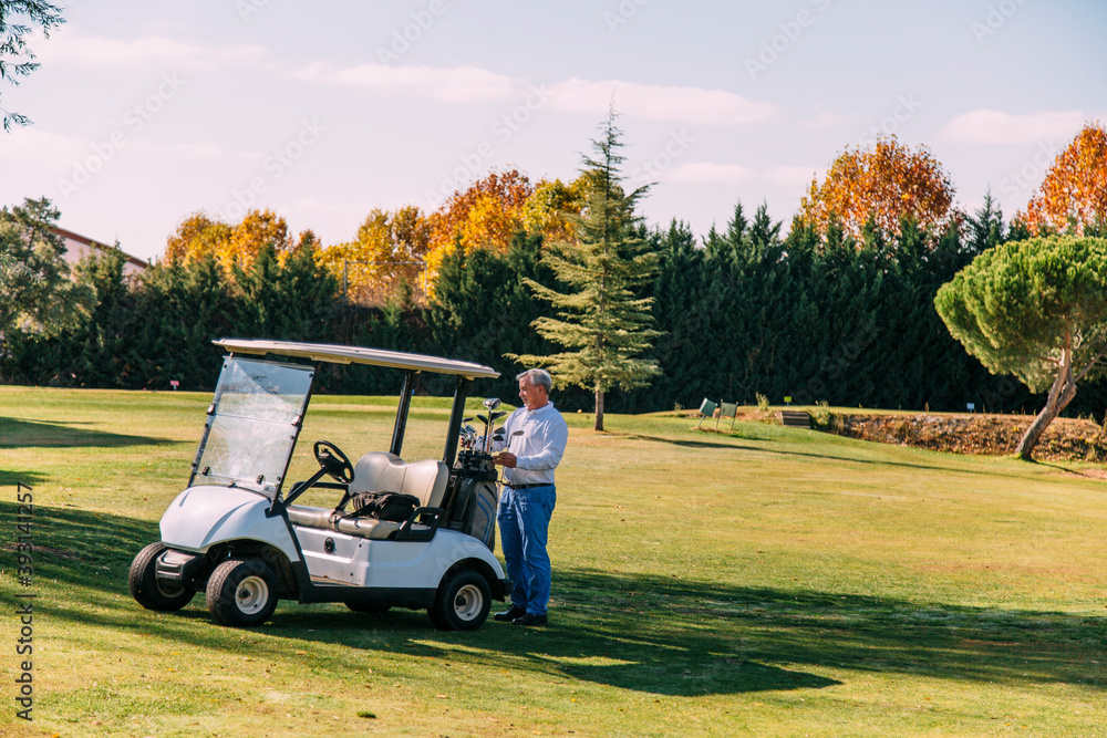 Golf cart on the course with colorful background