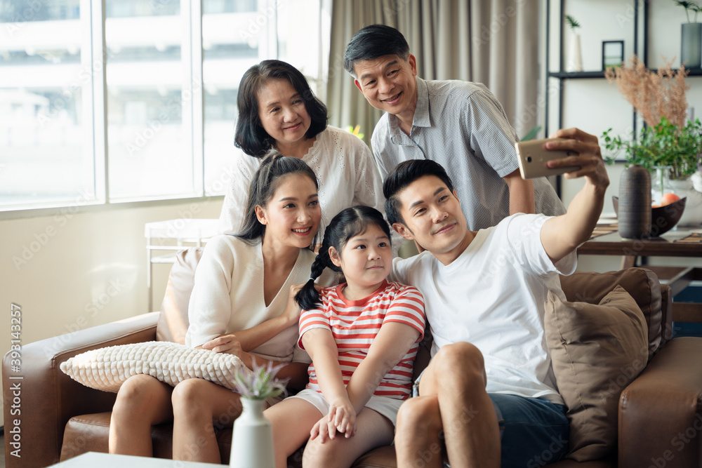Enjoy family taking selfies using mobile phone with smile and laughter, family portrait, quality time, grandparents and granddaughter Enjoy family taking selfies using mobile phone with smile and laughter, family portrait, quality time, grandparents and granddaughter