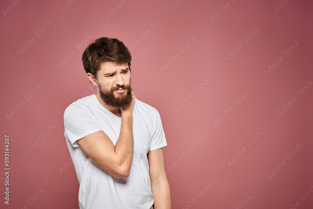 Man in white t-shirt emotions lifestyle facial expression cropped view pink background. Man in white t-shirt emotions lifestyle facial expression cropped view pink background.