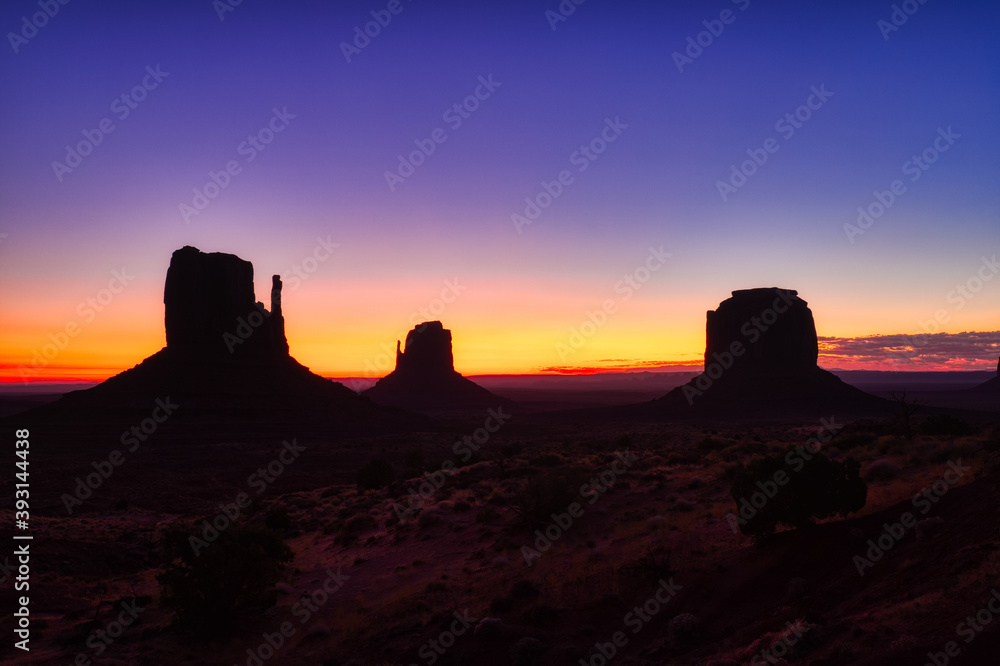 Monument Valley in Navajo National Park at Dusk, Border of Utah and Arizona Monument Valley in Navajo National Park at Dusk, Border of Utah and Arizona