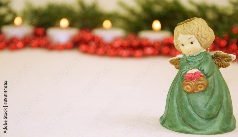 Christmas angel green red candels background 