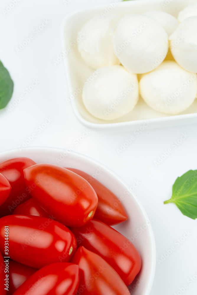 Mozzarella cheese, cherry tomatoes and basil leaves in composition Mozzarella cheese, cherry tomatoes and basil leaves in composition