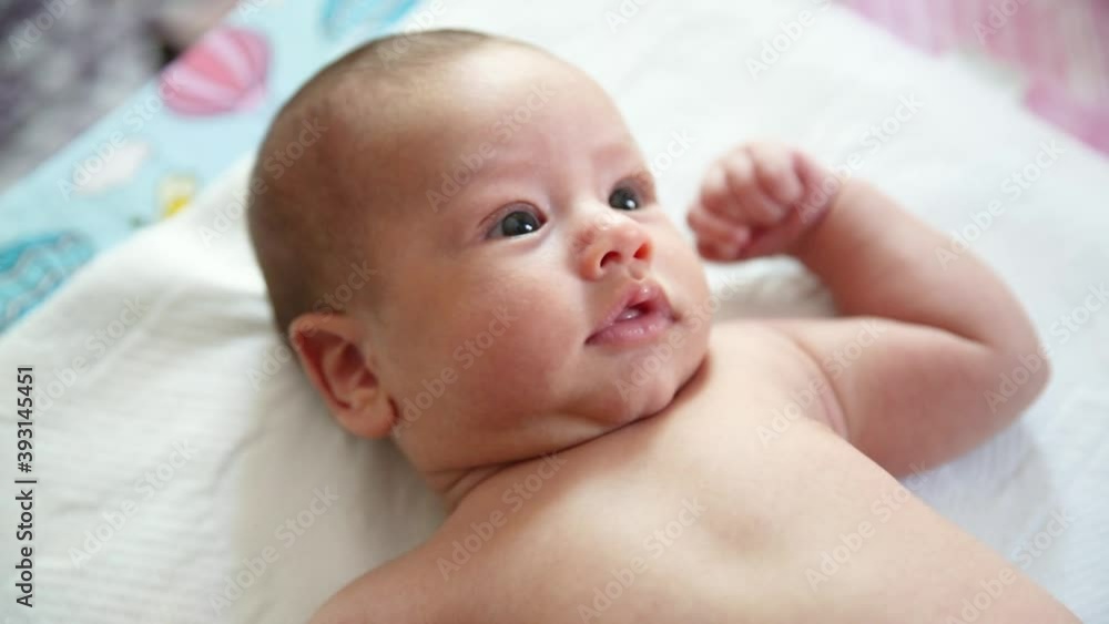 Close up shot of young mother is playing with her newborn baby in a nursery in a morning. Concept of maternity. Close up shot of young mother is playing with her newborn baby in a nursery in a morning. Concept of maternity.