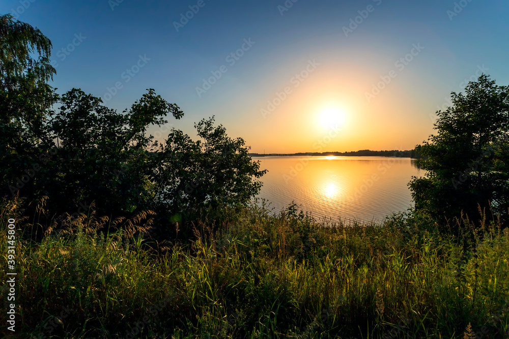 Obraz premium Golden sunset on the lake in Russia. Landscape summer.