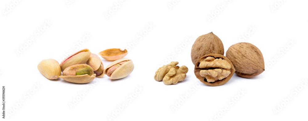 Pile of roasted pistachios and walnuts isolated on white background Pile of roasted pistachios and walnuts isolated on white background