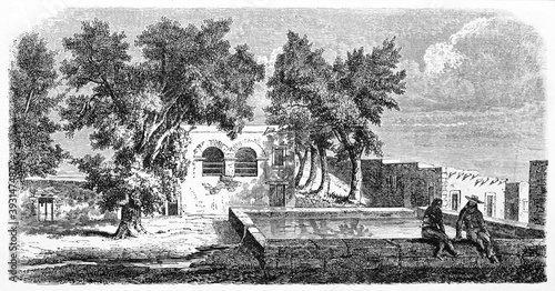 Two people seated on board of a squared fountain in Chihuahua city, Mexico. Ancient grey tone etching style art by Sargent on Le Tour du Monde, Paris, 1861