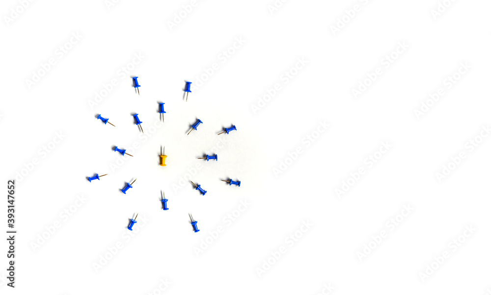 Yellow push pin in the center of the blue push pins with their spike facing yellow. The concept of aggression and attack Yellow push pin in the center of the blue push pins with their spike facing yellow. The concept of aggression and attack