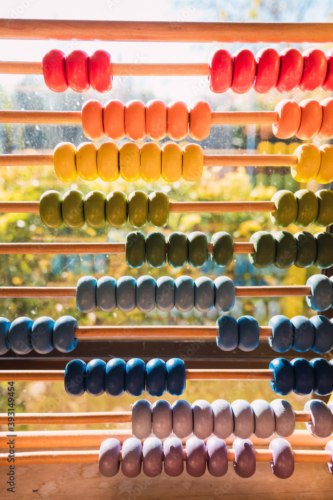 Detail of the colored beads of a wooden abacus, elementary educational material. Detail of the colored beads of a wooden abacus, elementary educational material.