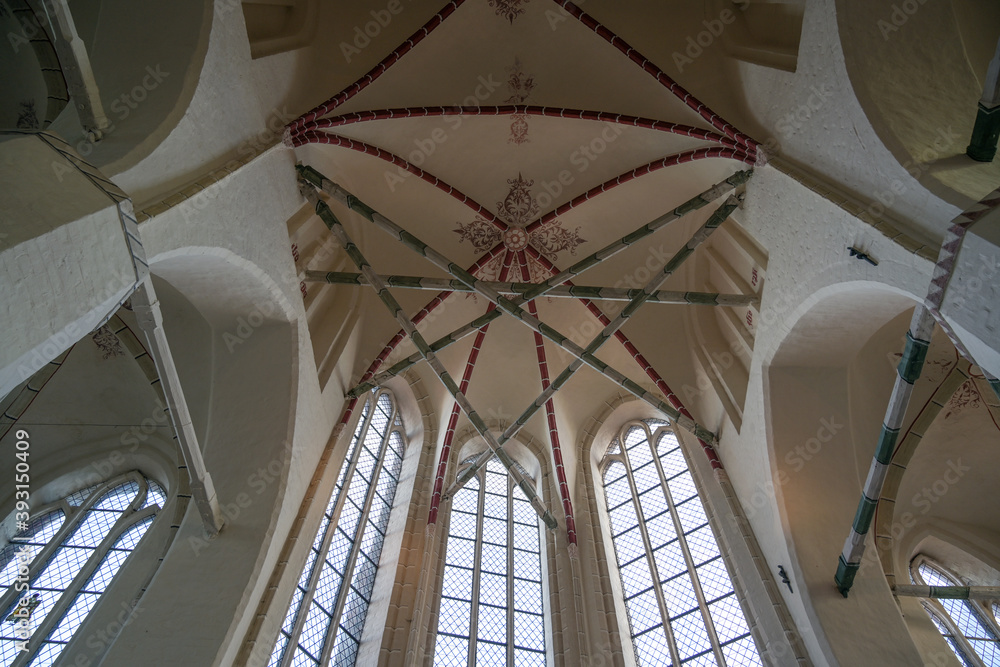 View from below into the basilical gothic rib vault with wooden struts in the town church of Gadebusch in northern Germany