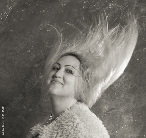 Attractive plump woman with flowing hair studio portrait close up view. photo