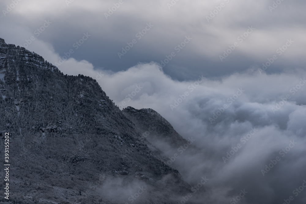 Spectacular scenery of Pyrenees mountain range covered with snow against cloudy sky in winter Spectacular scenery of Pyrenees mountain range covered with snow against cloudy sky in winter