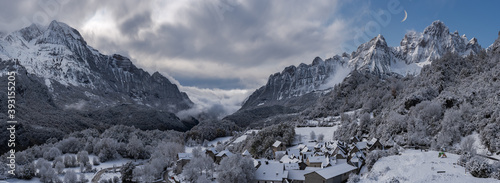 Amazing scenery of village with residential houses located in highland valley in Pyrenees in winter photo