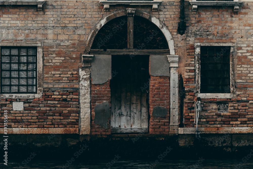 Old residential buildings with grungy exterior and arched ornate windows located in Venice Old residential buildings with grungy exterior and arched ornate windows located in Venice