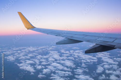 Wing of an airplane on blue sky