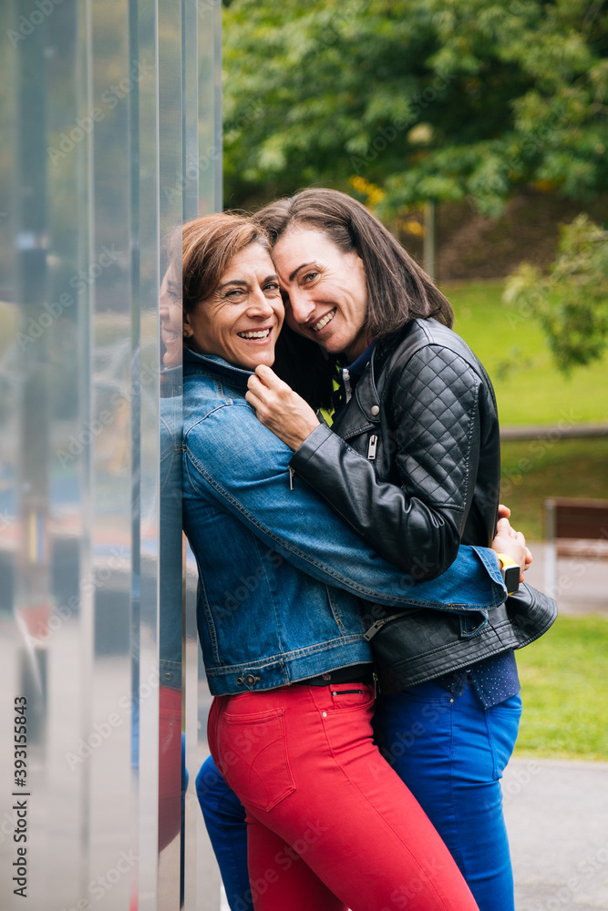 Portrait of a embracing middle aged lesbian couple Portrait of a embracing middle aged lesbian couple