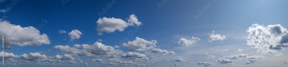Blue sky with clouds in sunshine (wide natural cloudscape background panorama) Blue sky with clouds in sunshine (wide natural cloudscape background panorama)