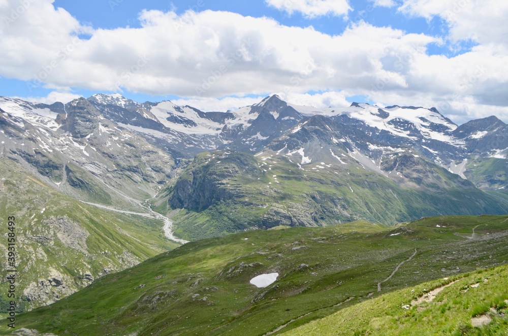 View of the mountains surrounding the birth of the Arc River and the alpine meadows from the trekking of the Refuge du Carro. Haute-Maurienne. French Alps 