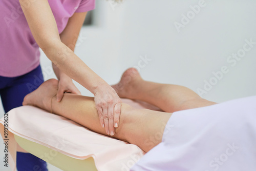 Wallpaper Mural Detail of hands massaging human calf muscle.Therapist applying pressure on female leg. Hands of massage therapist massaging legs of young woman in spa salon. Body care in spa salon for young woman. Torontodigital.ca