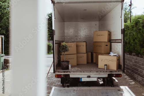 Cardboard boxes arranged in back of moving truck photo