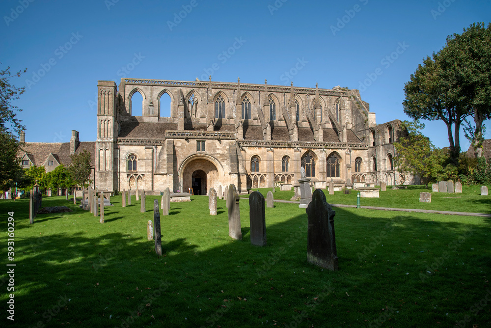 Malmesbury, Wiltshire, England, UK. 2020. The exterior of the 12th century Malmesbury Abbey and graveyard.