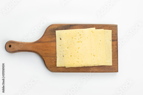 Sliced cheese on wooden desk