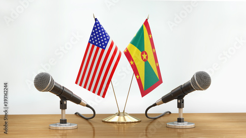 Microphones and flags pair on a desk over defocused background