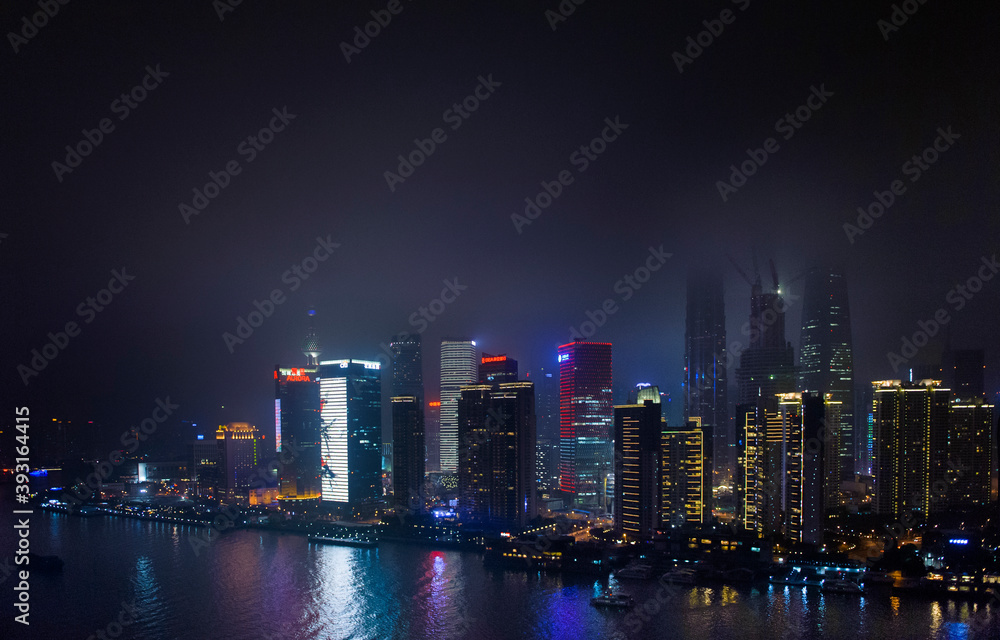 Scenic view of Shanghai skyline at night by Huangpu River Scenic view of Shanghai skyline at night by Huangpu River