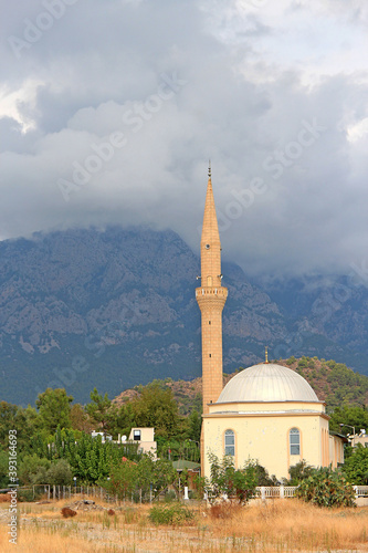 mosque with mountains and storm clouds in the background